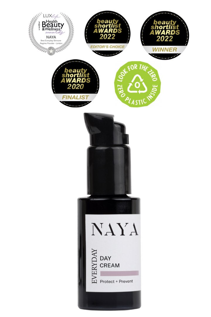 NAYA Everyday Day Cream bottle with various awards and certifications on a white background