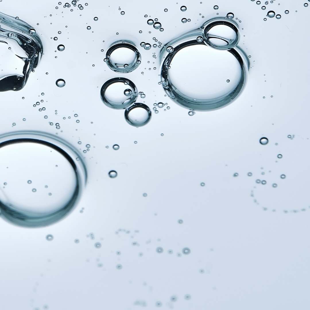 Close-up of water bubbles on a light blue background